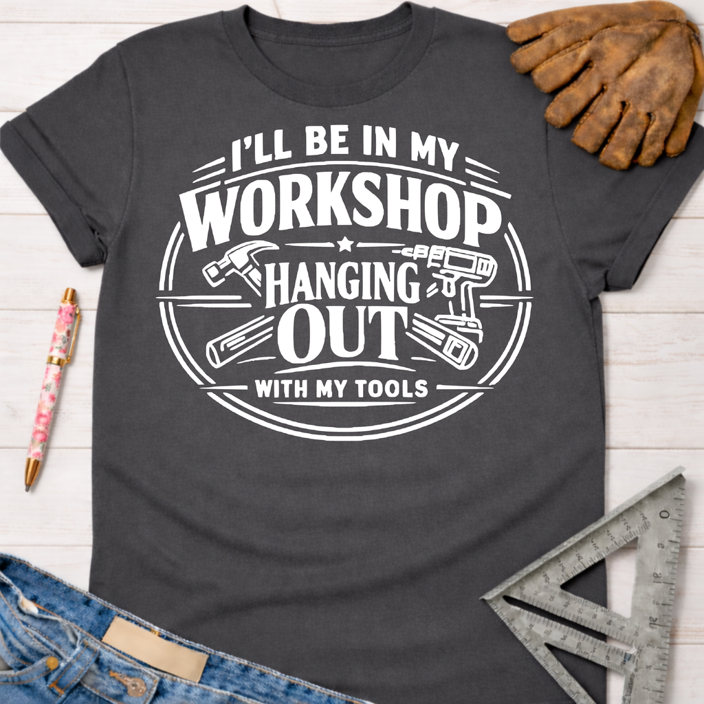 Women's funny woodworking graphic tee shirt for female woodworkers, makers, and DIY builders — Sawdust & Ponytails. Dark gray cotton tee with "I'll be in my workshop hanging out with my tools" graphic.
