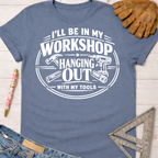Women's funny woodworking graphic tee shirt for female woodworkers, makers, and DIY builders — Sawdust & Ponytails. Blue cotton tee with "I'll Be In My Workshop Hanging Out With My Tools" graphic.