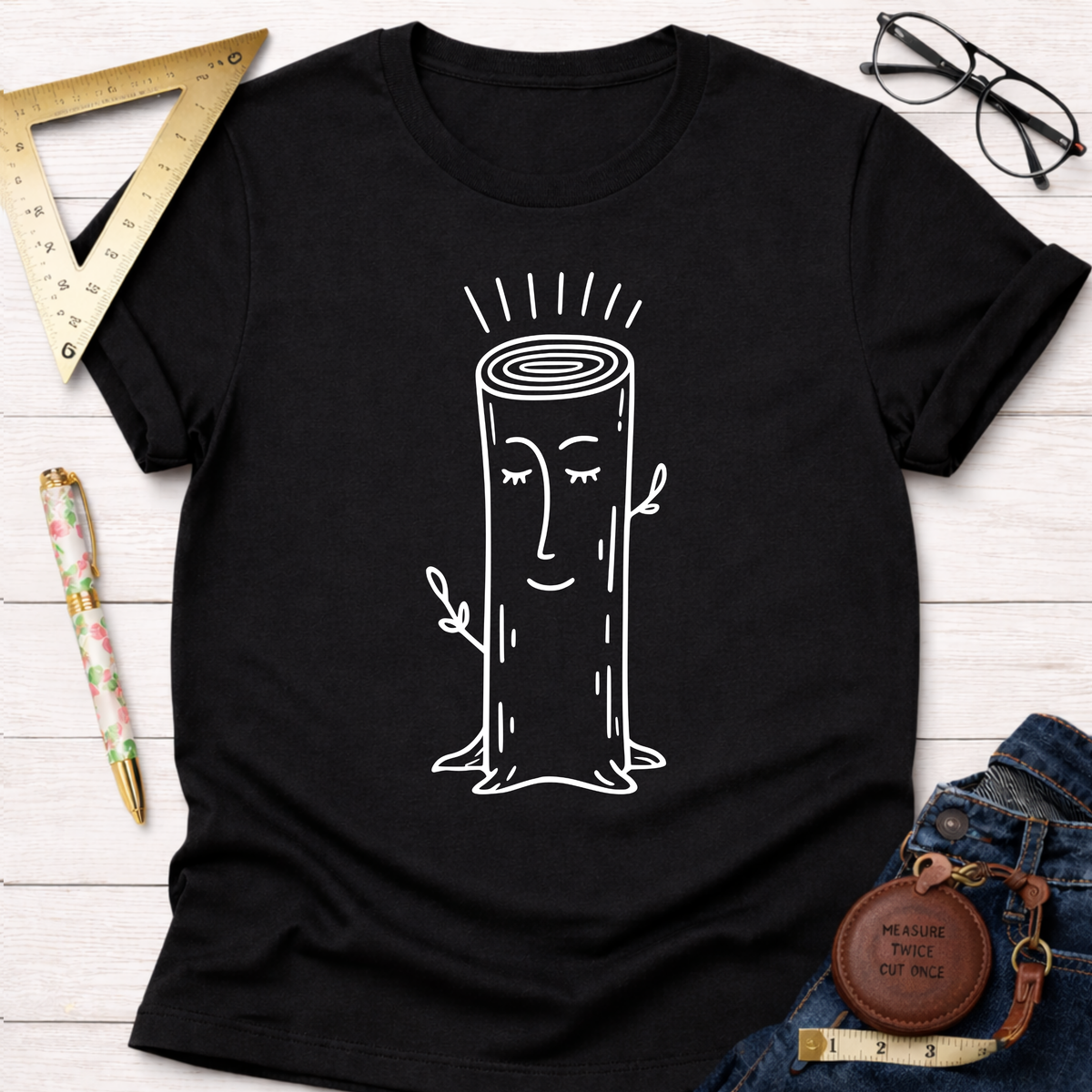 Black cotton Women's funny woodworking graphic tee shirt for female woodworkers, makers, and DIY builders — Sawdust & Ponytails, featuring a white cartoon tree stump design.