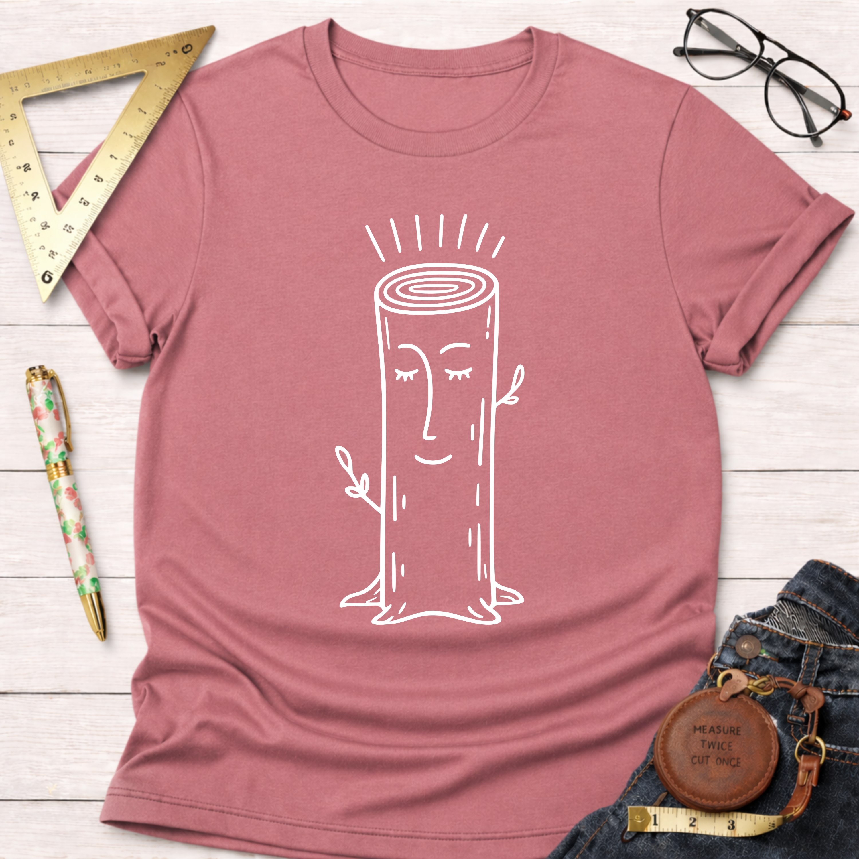 Women's funny woodworking graphic tee shirt for female woodworkers, makers, and DIY builders — Sawdust & Ponytails. Dusty rose crewneck t-shirt with a smiling tree stump graphic.