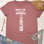 Women's funny woodworking graphic tee shirt for female woodworkers, makers, and DIY builders — Sawdust & Ponytails. Mauve cotton t-shirt with "HIT IT until it works OR UNTIL YOU FEEL BETTER" in white text.