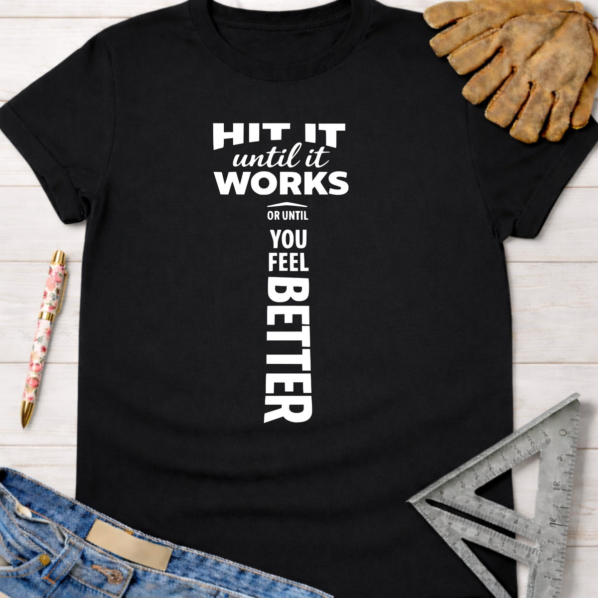 Black cotton "Hit It Until It Works" graphic tee for women, with a hammer design, perfect for woodworkers.