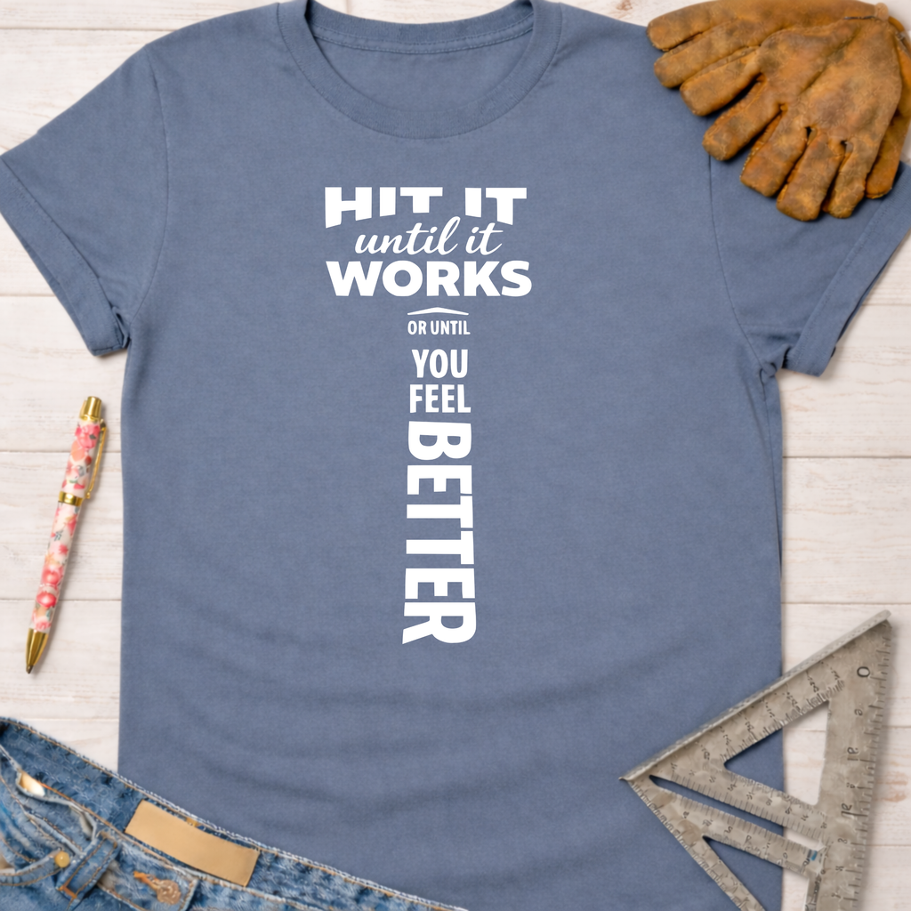 Women's funny woodworking graphic tee shirt for female woodworkers, makers, and DIY builders — Sawdust & Ponytails. Blue cotton tee with "Hit It Until It Works Or Until You Feel Better" text.