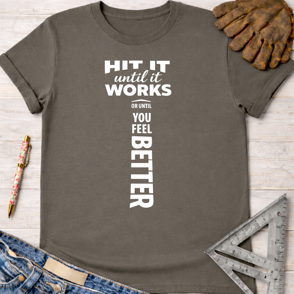 Women's funny woodworking graphic tee shirt for female woodworkers, makers, and DIY builders — Sawdust & Ponytails. Dark gray t-shirt with "HIT IT until it works OR UNTIL YOU FEEL BETTER" in white text, forming a hammer shape.