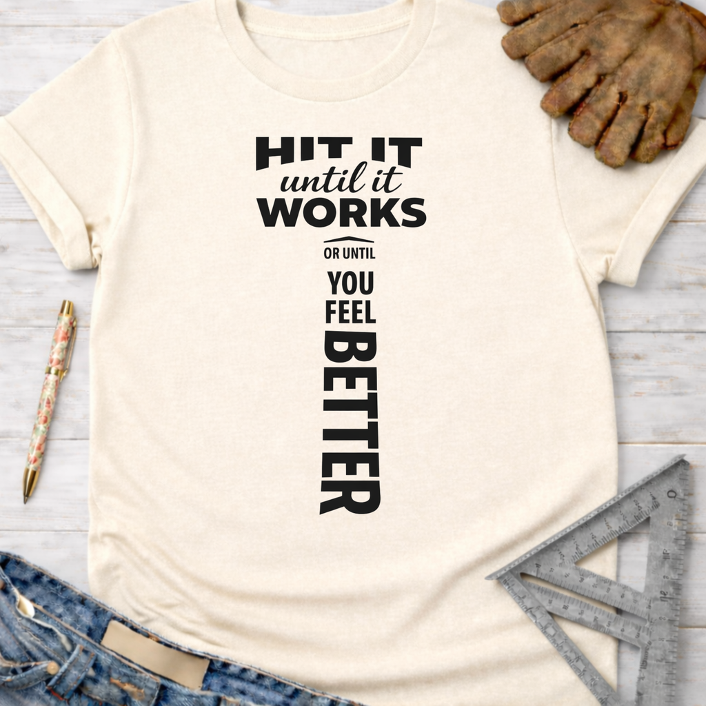 Women's funny woodworking graphic tee shirt for female woodworkers, makers, and DIY builders — Sawdust & Ponytails. Cream t-shirt with "HIT IT until it WORKS OR UNTIL YOU FEEL BETTER" text, with a hammer graphic.