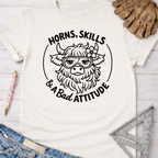 Women's funny woodworking graphic tee shirt for female woodworkers, makers, and DIY builders — Sawdust & Ponytails. White cotton tee with a black graphic of a horned cow wearing goggles and a flower, text "HORNS, SKILLS & A Bad ATTITUDE".