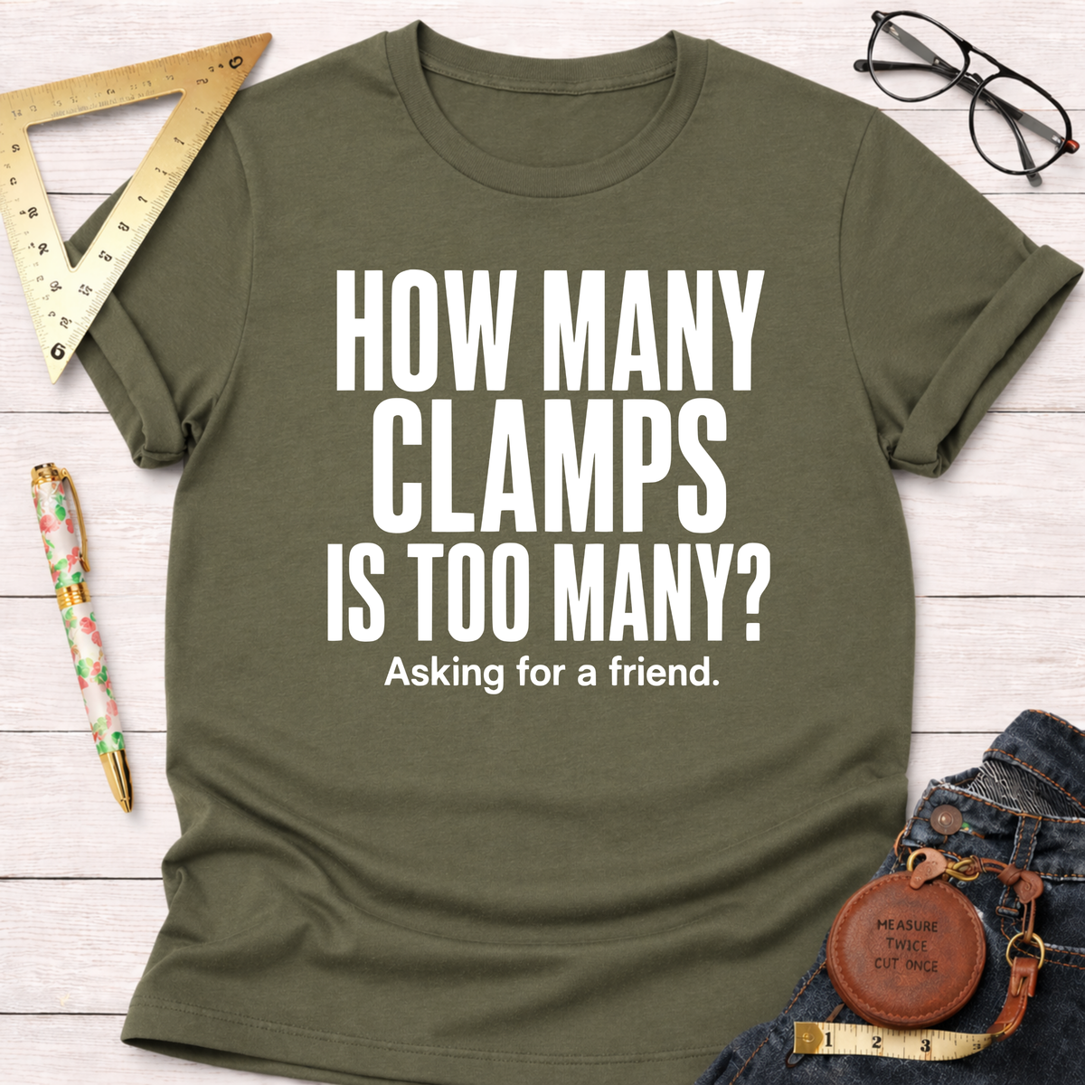 Olive green t-shirt with "HOW MANY CLAMPS IS TOO MANY? Asking for a friend." in white text.