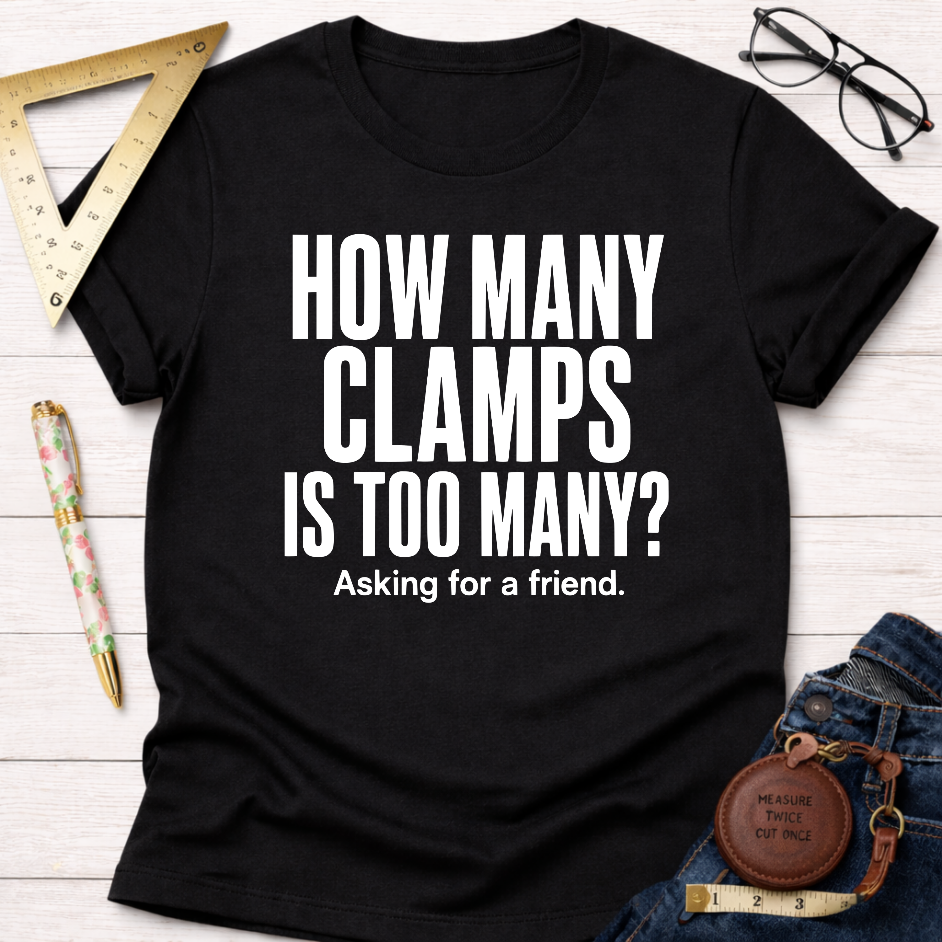 Black cotton t-shirt with "HOW MANY CLAMPS IS TOO MANY? Asking for a friend." in white text.