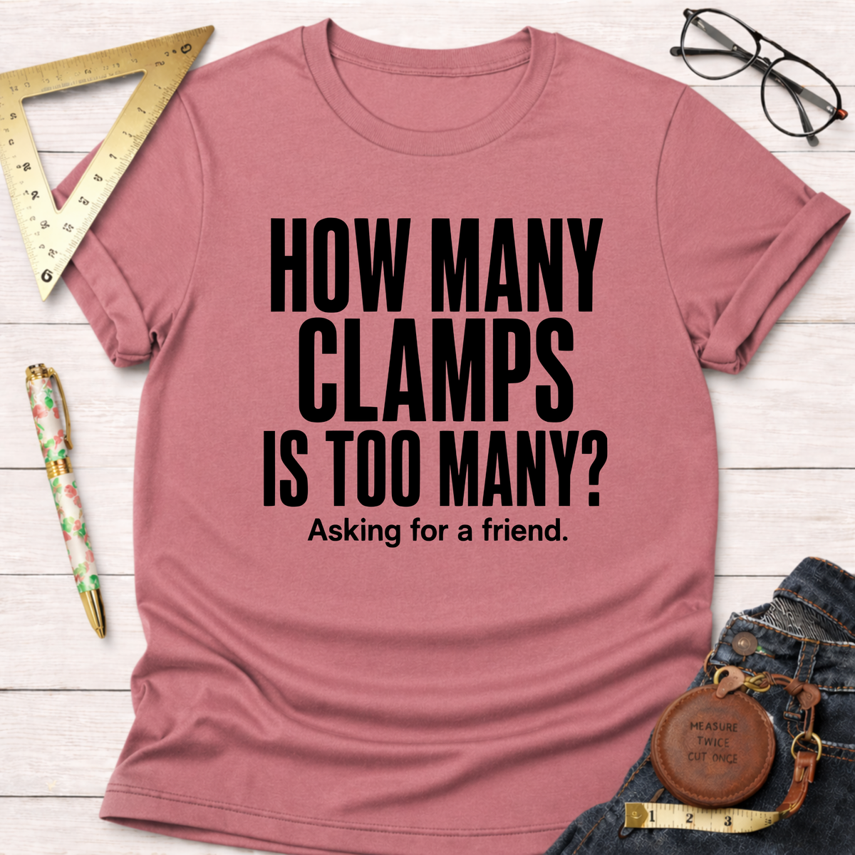Heather dust pink t-shirt with "HOW MANY CLAMPS IS TOO MANY? Asking for a friend." in black text.