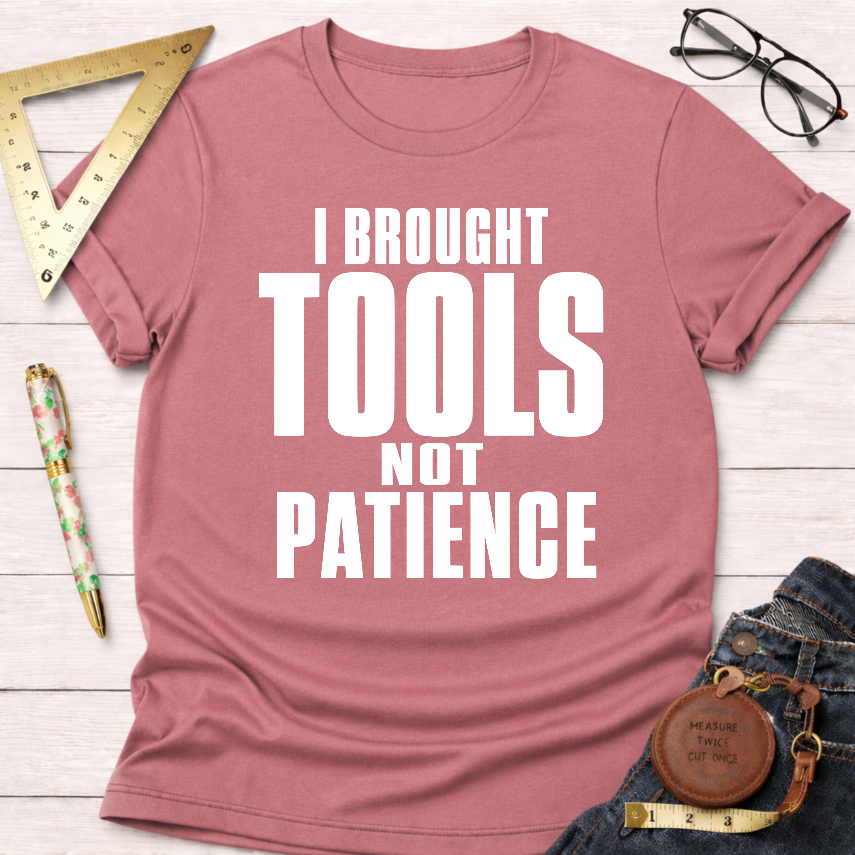 Women's funny woodworking graphic tee shirt for female woodworkers, makers, and DIY builders — Sawdust & Ponytails. Mauve pink t-shirt with "I BROUGHT TOOLS NOT PATIENCE" in white text.