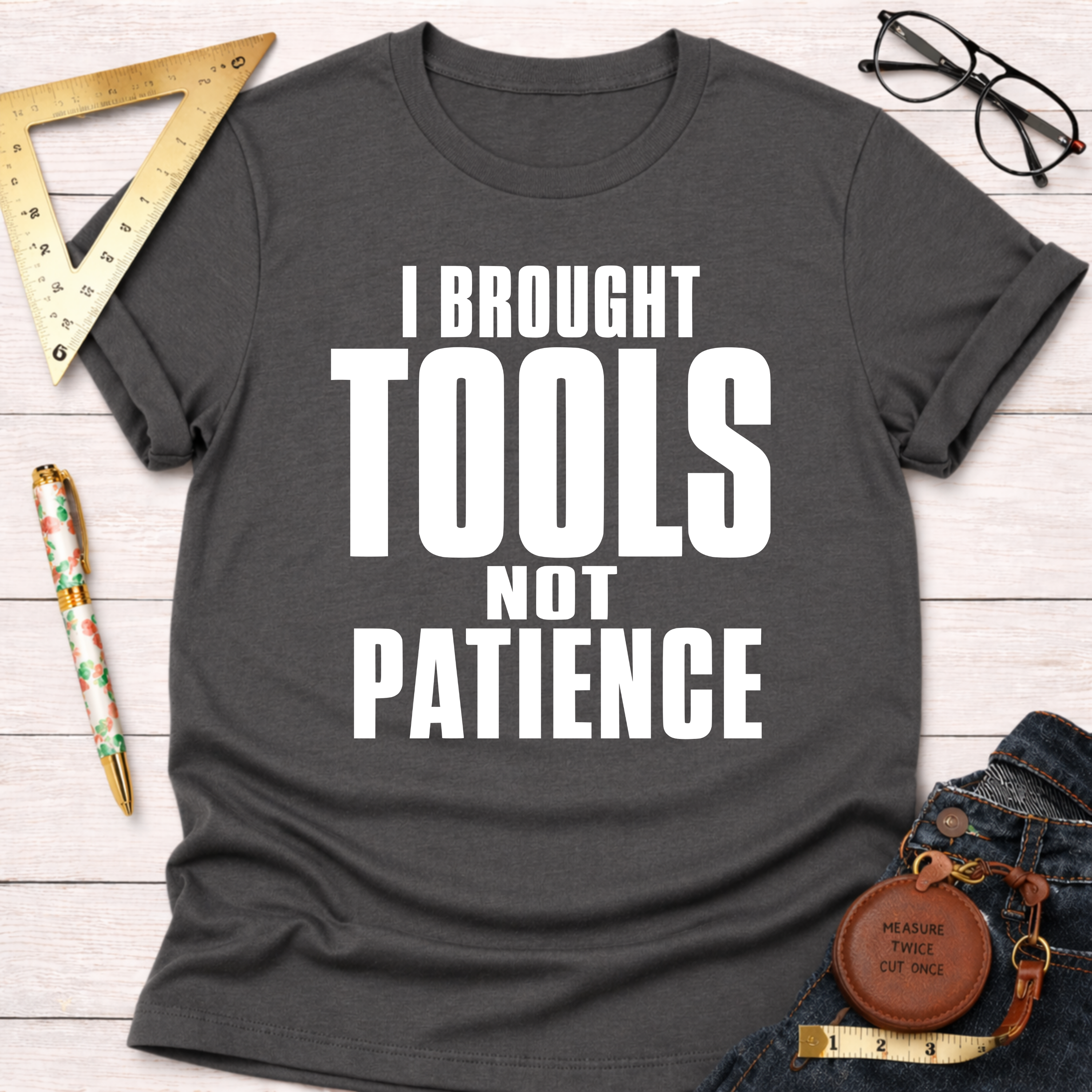 Women's funny woodworking graphic tee shirt for female woodworkers, makers, and DIY builders — Sawdust & Ponytails. Dark gray t-shirt with "I BROUGHT TOOLS NOT PATIENCE" in white text.