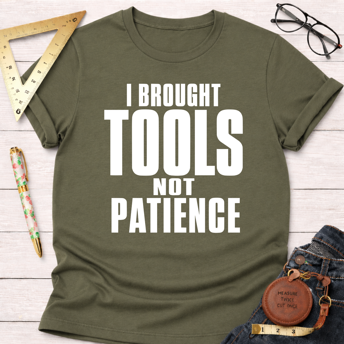 Women's funny woodworking graphic tee shirt for female woodworkers, makers, and DIY builders — Sawdust & Ponytails. Olive green cotton tee with "I BROUGHT TOOLS NOT PATIENCE" in white text.