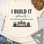 Women's funny woodworking graphic tee shirt for female woodworkers, makers, and DIY builders — Sawdust & Ponytails. Cream "I BUILD IT plants" graphic tee with plant pots.