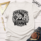 Cream t-shirt with "I Build Stuff & Occasionally Behave" graphic featuring a woman with a drill and coffee.