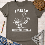 Women's funny woodworking graphic tee shirt for female woodworkers, makers, and DIY builders — Sawdust & Ponytails. Dark gray cotton tee with a white graphic of a goose holding a hammer and the text "I BUILD THEREFORE I SWEAR".