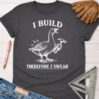 Women's funny woodworking graphic tee shirt for female woodworkers, makers, and DIY builders — Sawdust & Ponytails. Dark gray cotton tee with a white graphic of a goose holding a hammer and the text "I BUILD THEREFORE I SWEAR.