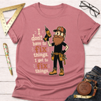 Pink cotton t-shirt with a bearded handyman holding a drill and the text "I don't have to fix things. I get to fix things.