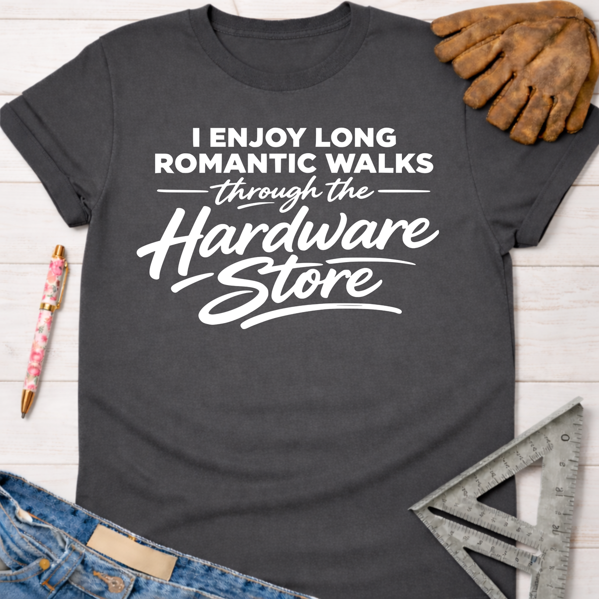 Charcoal gray women's funny graphic tee with "I Enjoy Long Romantic Walks Through the Hardware Store" in white text.