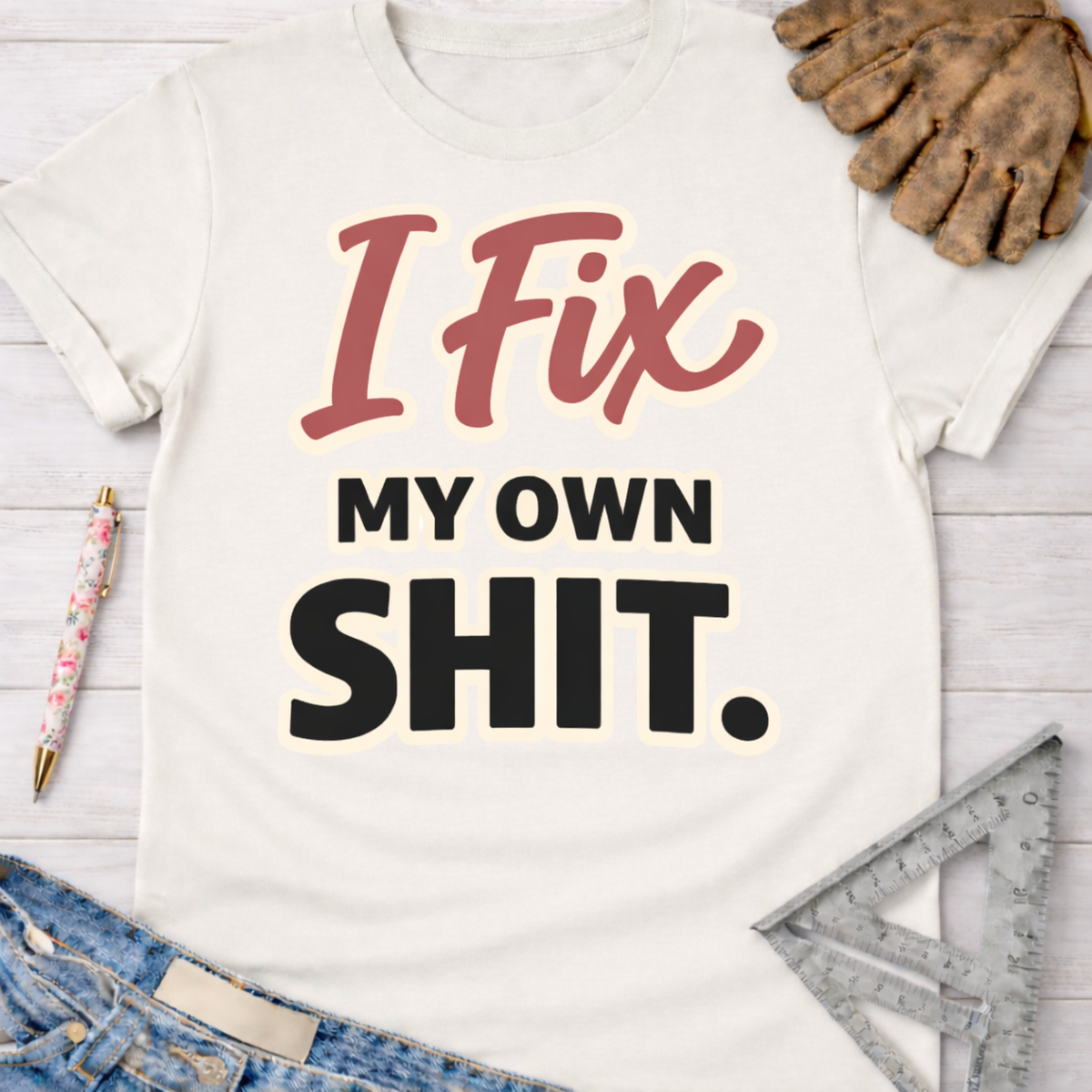 Women's funny woodworking graphic tee shirt for female woodworkers, makers, and DIY builders — Sawdust & Ponytails. Cream t-shirt with "I Fix My Own Shit" text.