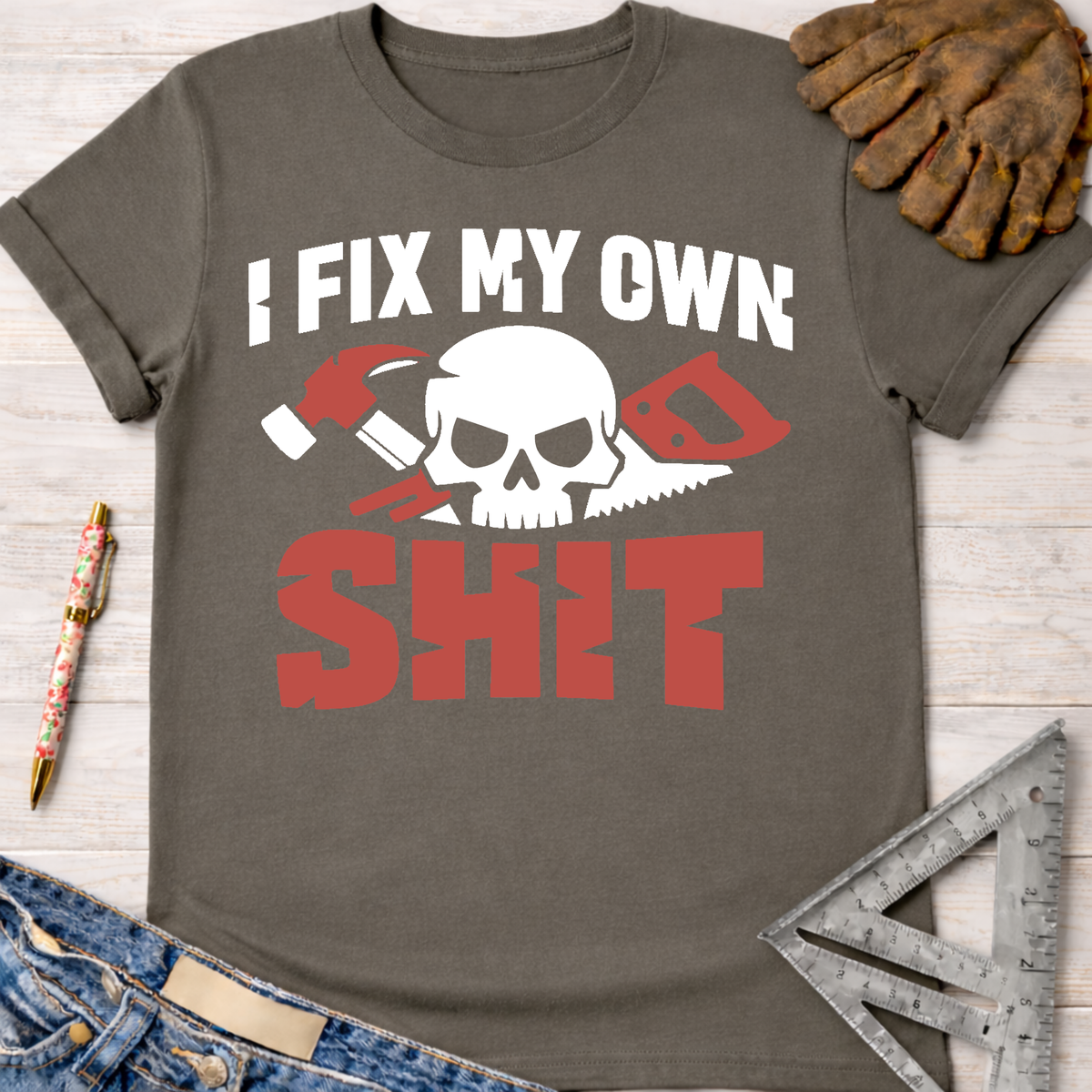 Women's funny woodworking graphic tee shirt for female woodworkers, makers, and DIY builders — Sawdust & Ponytails. Charcoal grey t-shirt with "I FIX MY OWN SHIT" text and skull, hammer, saw graphic.