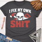Charcoal gray "I Fix My Own Shit" graphic tee with skull, hammer, and saw design. Women's funny woodworking graphic tee shirt for female woodworkers, makers, and DIY builders — Sawdust & Ponytails.