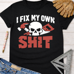 Black cotton t-shirt with "I FIX MY OWN SHIT" text, skull, hammer, and saw graphic. Women's funny woodworking graphic tee shirt for female woodworkers, makers, and DIY builders — Sawdust & Ponytails