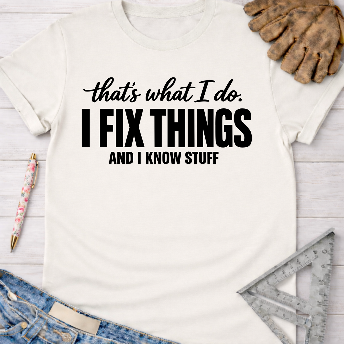 Women's funny woodworking graphic tee shirt for female woodworkers, makers, and DIY builders — Sawdust & Ponytails. Cream t-shirt with "I FIX THINGS AND I KNOW STUFF" text.