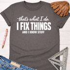 Women's funny woodworking graphic tee shirt for female woodworkers, makers, and DIY builders — Sawdust & Ponytails. Dark gray cotton tee with "I FIX THINGS AND I KNOW STUFF" in white.