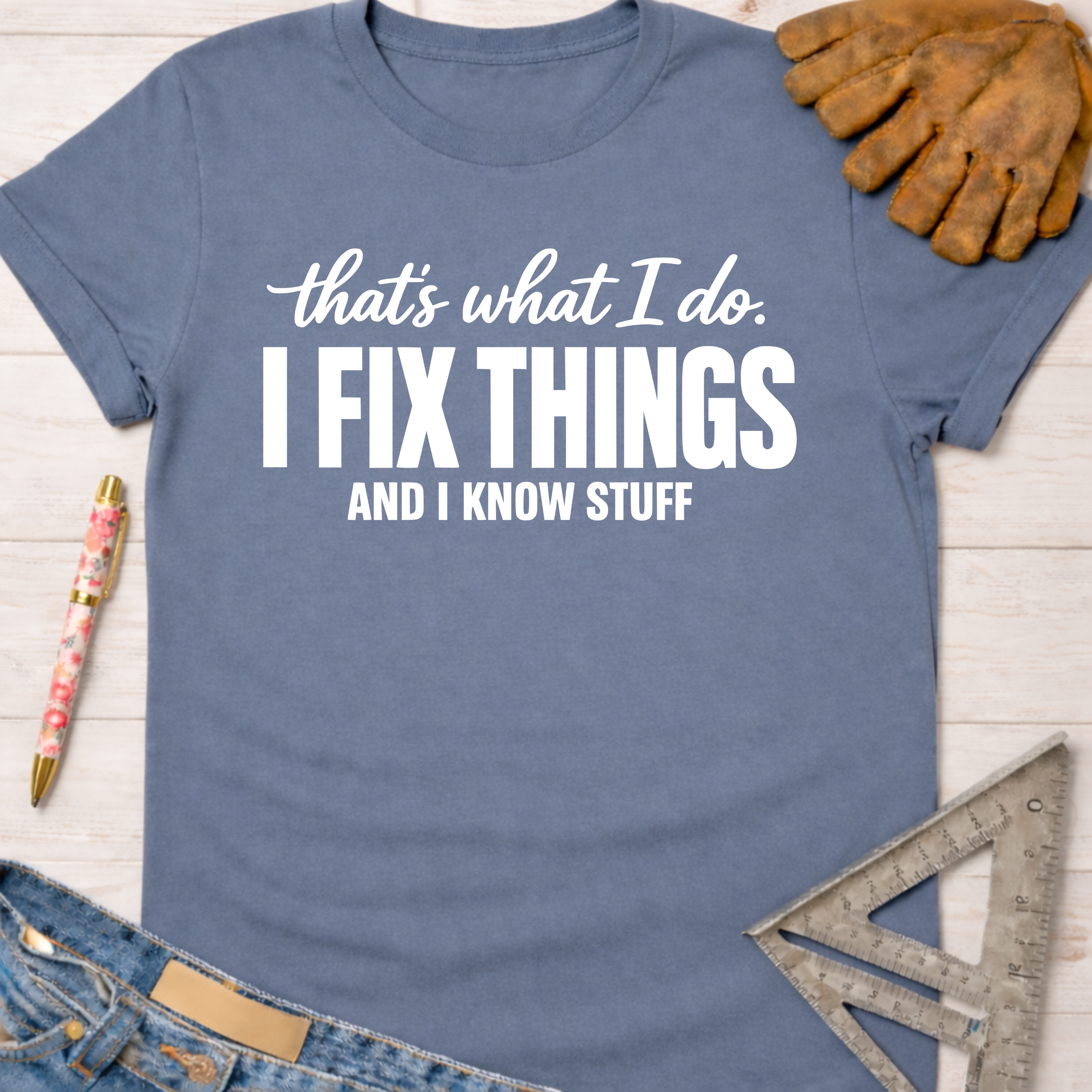 Women's funny woodworking graphic tee shirt for female woodworkers, makers, and DIY builders — Sawdust & Ponytails. Blue cotton tee with "I FIX THINGS AND I KNOW STUFF" text.