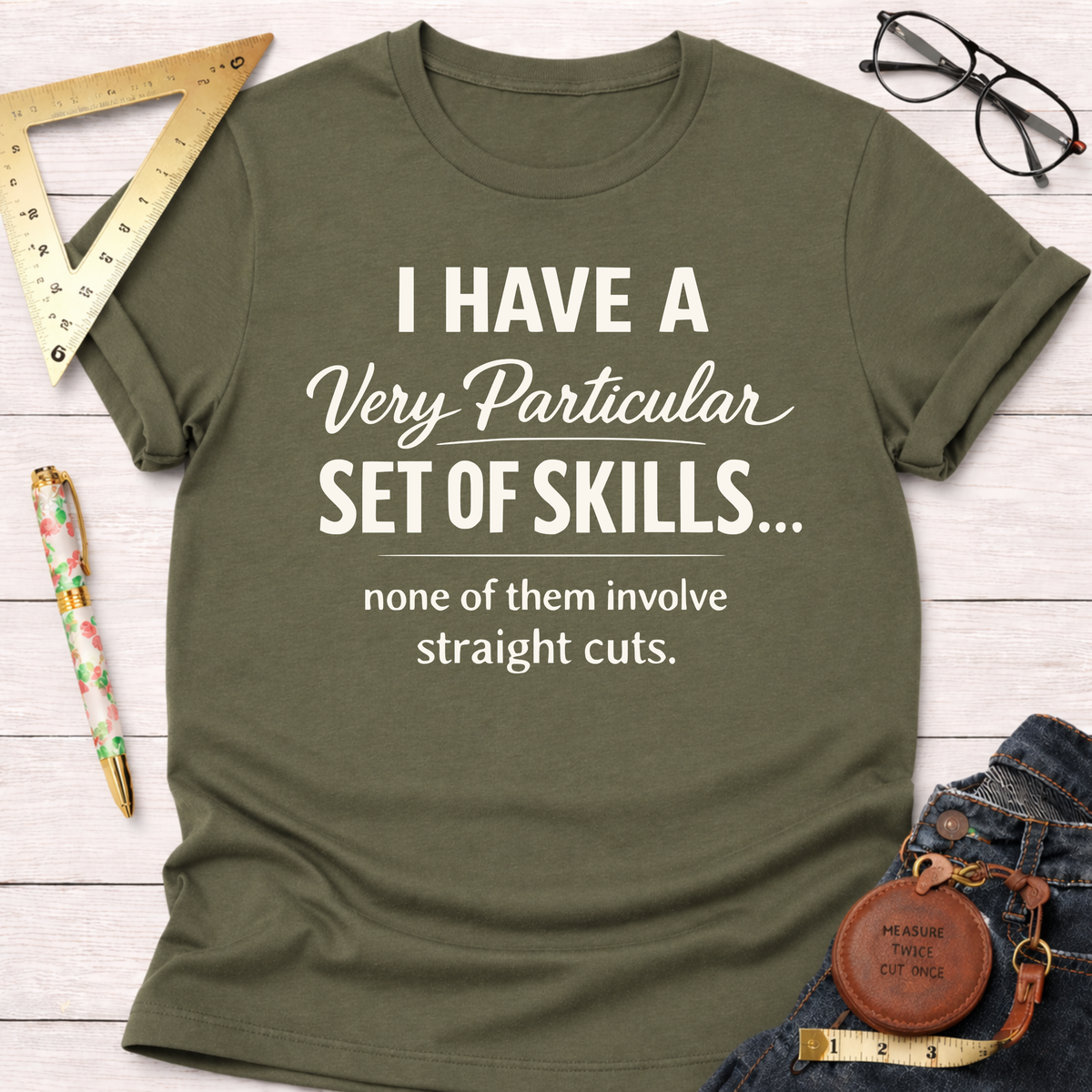 Heather mauve t-shirt with "I have a very particular set of skills... none of them involve straight cuts" text.
