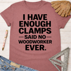 Women's funny woodworking graphic tee shirt for female woodworkers, makers, and DIY builders — Sawdust & Ponytails. Mauve cotton tee with "I HAVE ENOUGH CLAMPS — SAID NO — WOODWORKER EVER." in black text.
