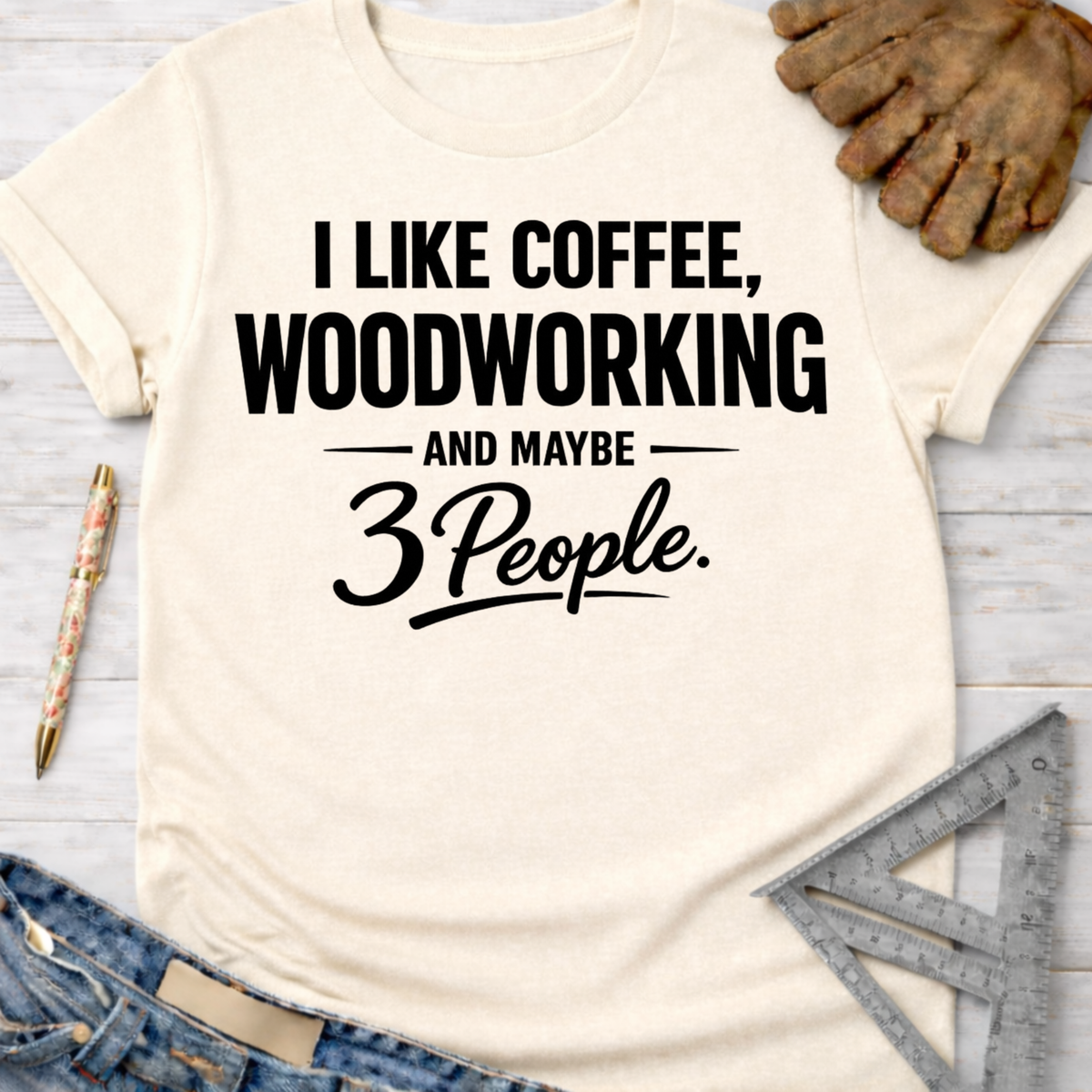 Women's funny woodworking graphic tee shirt for female woodworkers, makers, and DIY builders — Sawdust & Ponytails. Cream t-shirt with "I Like Coffee, Woodworking And Maybe 3 People" in black text.