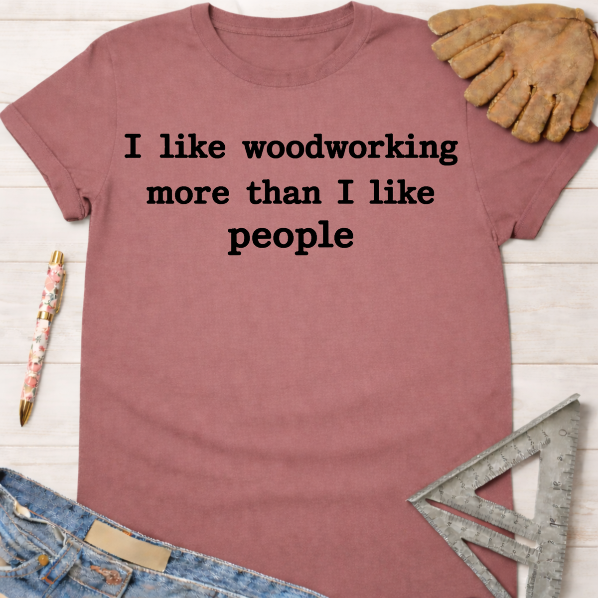 Women's funny woodworking graphic tee shirt for female woodworkers, makers, and DIY builders — Sawdust & Ponytails. Mauve cotton tee with "I like woodworking more than I like people" text.