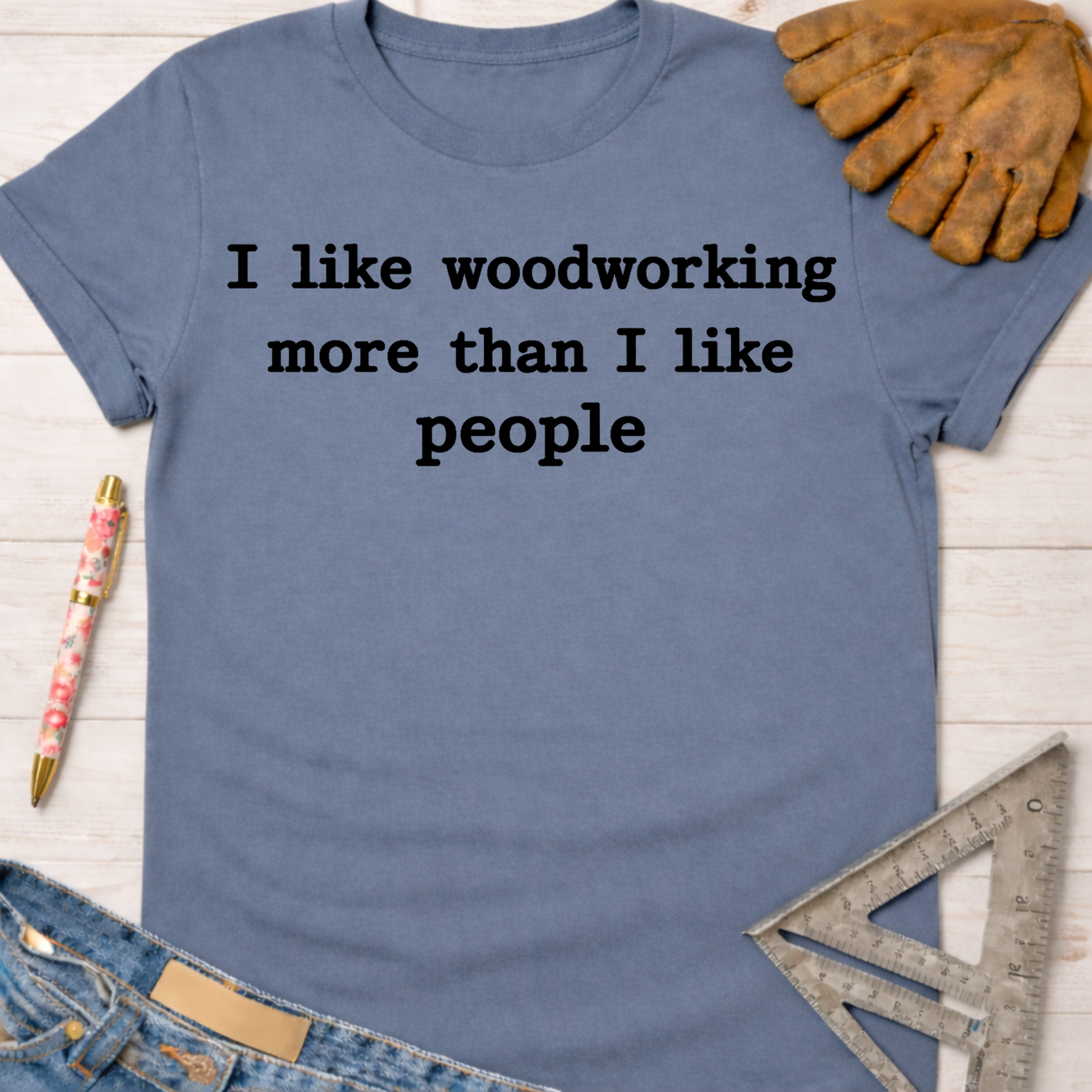 Women's funny woodworking graphic tee shirt for female woodworkers, makers, and DIY builders — Sawdust & Ponytails. Blue cotton tee with "I like woodworking more than I like people" text.