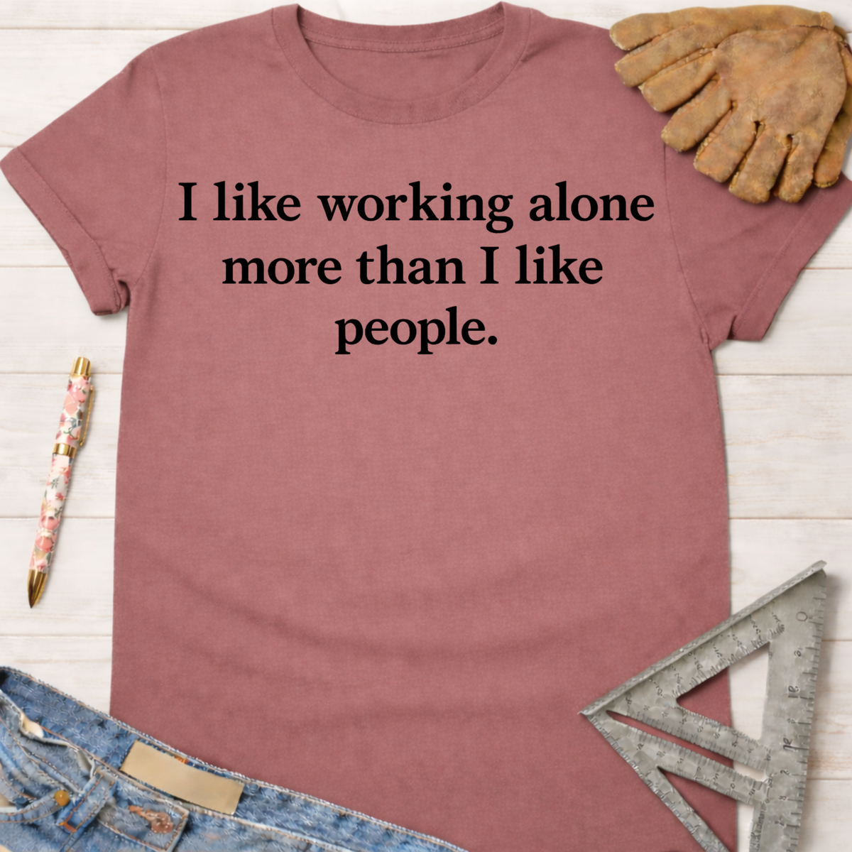 Women's funny woodworking graphic tee shirt for female woodworkers, makers, and DIY builders — Sawdust & Ponytails. Mauve cotton tee with "I like working alone more than I like people" text.