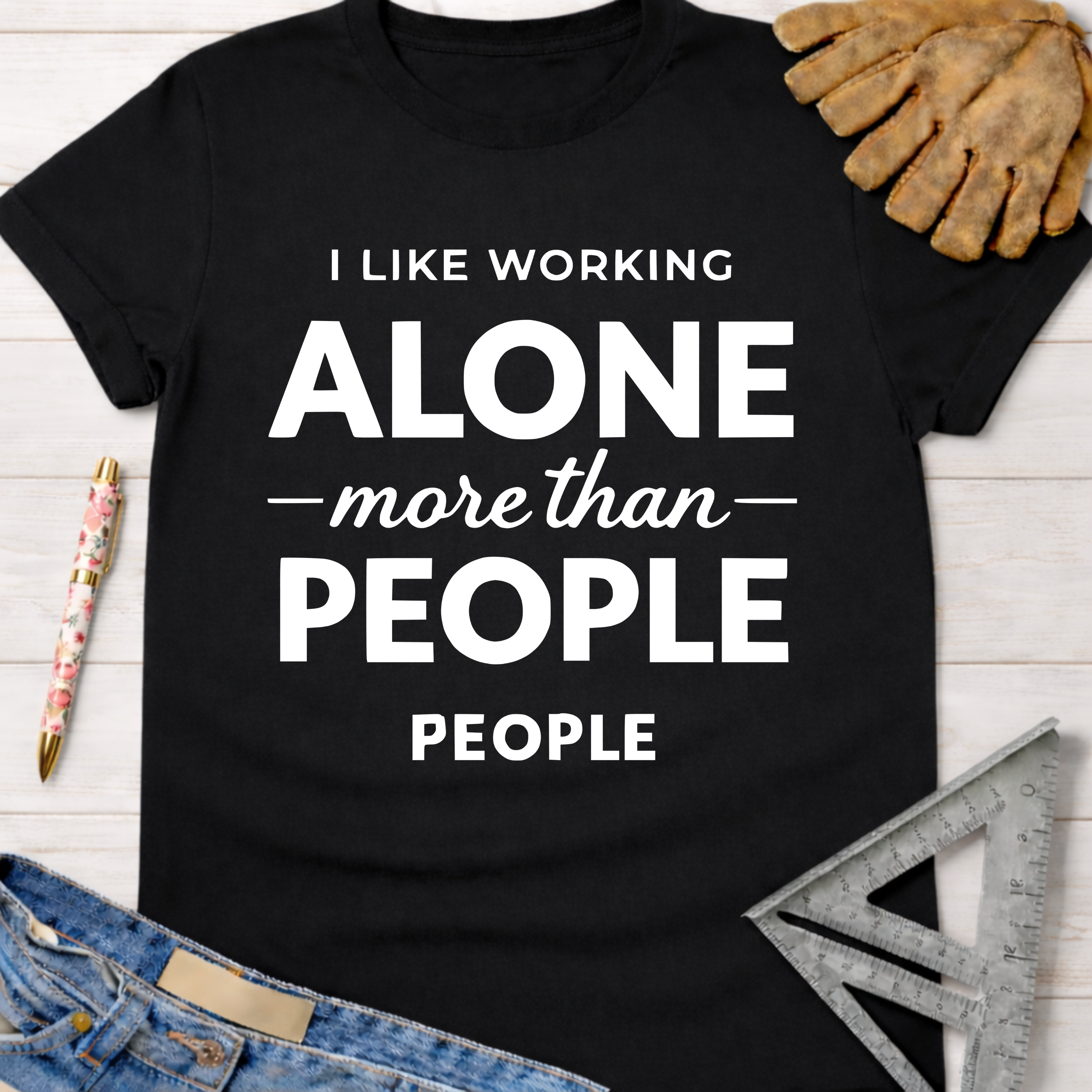 Women's funny woodworking graphic tee shirt for female woodworkers, makers, and DIY builders — Sawdust & Ponytails. Black cotton tee with "I LIKE WORKING ALONE more than PEOPLE" in white text.