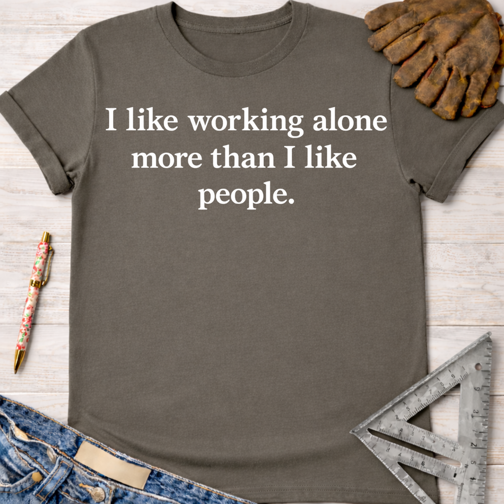 Women's funny woodworking graphic tee shirt for female woodworkers, makers, and DIY builders — Sawdust & Ponytails. Dark gray cotton tee with white "I like working alone more than I like people" text.