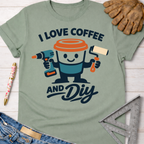 Women's funny woodworking graphic tee shirt for female woodworkers, makers, and DIY builders — Sawdust & Ponytails. Sage green cotton tee with "I Love Coffee and DIY" graphic featuring a coffee cup holding a drill and paint roller.