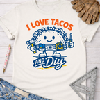 Women's funny woodworking graphic tee shirt for female woodworkers, makers, and DIY builders — Sawdust & Ponytails. White cotton tee with "I Love Tacos And DIY" graphic featuring a taco character with tools.