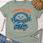 Sage green women's funny "I Love Tacos and DIY" graphic tee with a taco character holding tools.
