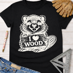 Black cotton "I Love Wood" beaver graphic tee for women, with leather gloves, jeans, and a ruler. Sawdust & Ponytails.