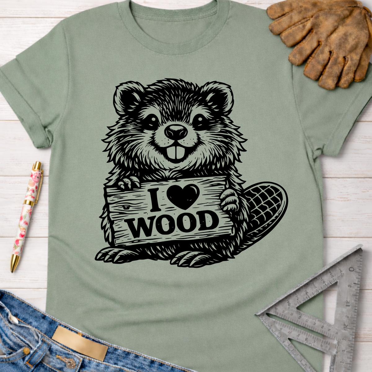 Sage green women's funny woodworking graphic tee with a beaver holding an "I Love Wood" sign. Sawdust & Ponytails.