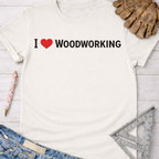 Women's funny woodworking graphic tee shirt for female woodworkers, makers, and DIY builders — Sawdust & Ponytails. Cream cotton tee with "I ❤️ WOODWORKING" text.