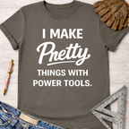 Women's funny woodworking graphic tee shirt for female woodworkers, makers, and DIY builders — Sawdust & Ponytails. Dark gray cotton tee with "I Make Pretty Things With Power Tools" in white text.