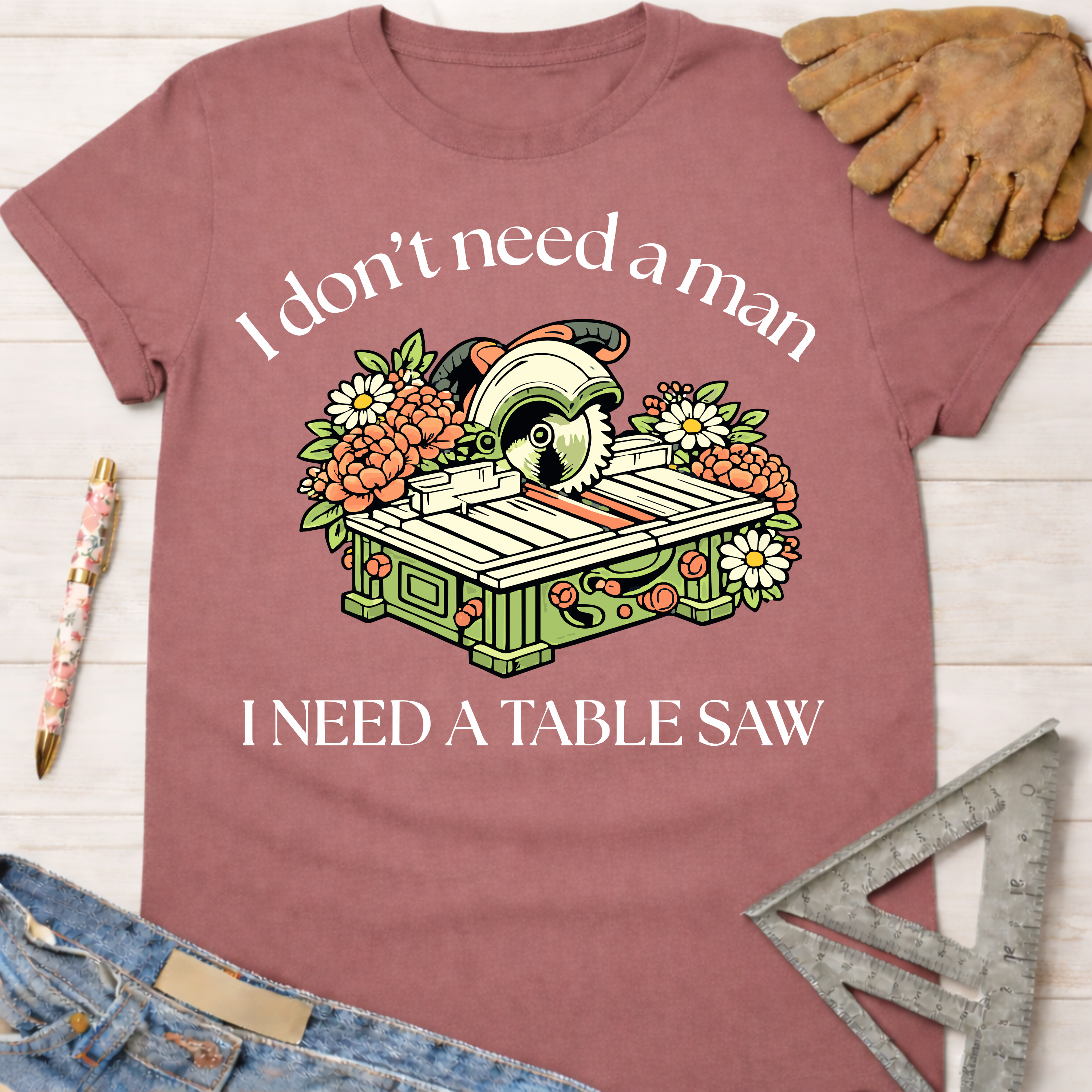 Women's funny woodworking graphic tee shirt for female woodworkers, makers, and DIY builders — Sawdust & Ponytails. Mauve cotton tee with "I don't need a man, I need a table saw" graphic.