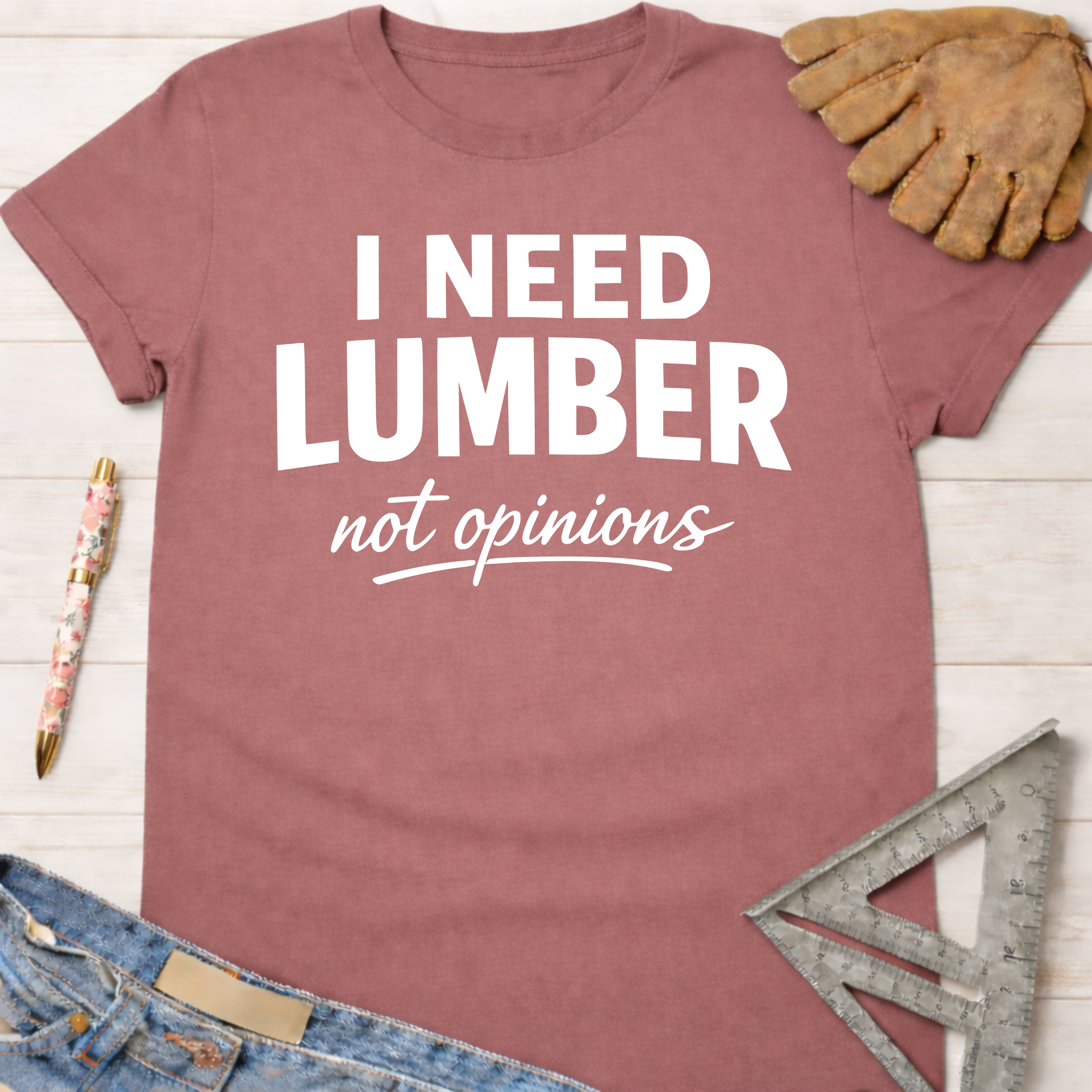 Women's funny woodworking graphic tee shirt for female woodworkers, makers, and DIY builders — Sawdust & Ponytails. Mauve cotton t-shirt with "I NEED LUMBER not opinions" in white text.