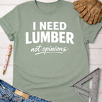 Women's funny woodworking graphic tee shirt for female woodworkers, makers, and DIY builders — Sawdust & Ponytails. Sage green cotton t-shirt with "I NEED LUMBER not opinions" in white text.