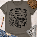 Women's funny woodworking graphic tee shirt for female woodworkers, makers, and DIY builders — Sawdust & Ponytails. Dark gray cotton tee with "YES I REALLY DO NEED ALL THESE Power Tools" graphic.
