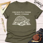 Women's funny woodworking graphic tee shirt for female woodworkers, makers, and DIY builders — Sawdust & Ponytails. Olive green cotton tee with "I Reckon I'll Finish When I Finish" and a white turtle graphic.