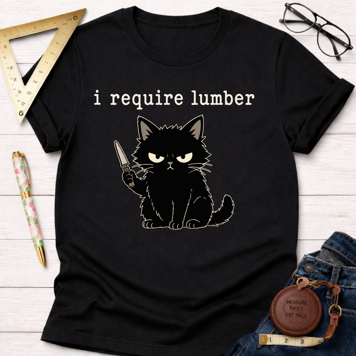 Black cotton t-shirt with an angry black cat holding a knife and "i require lumber" text.